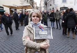 Demonstrator with a Je Suis Charlie Badge